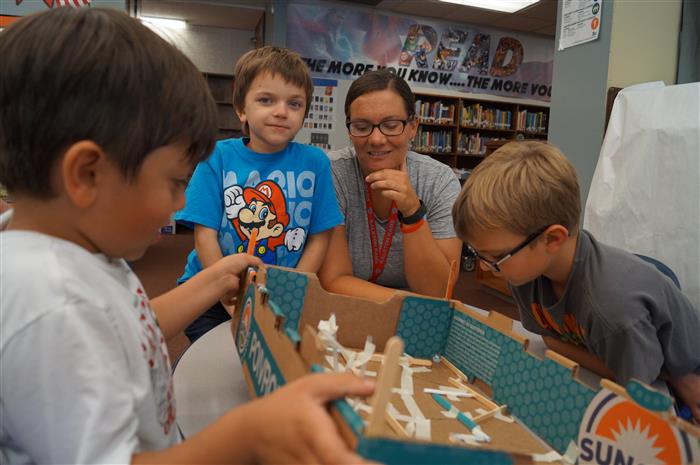 Photo of students with teacher working on project